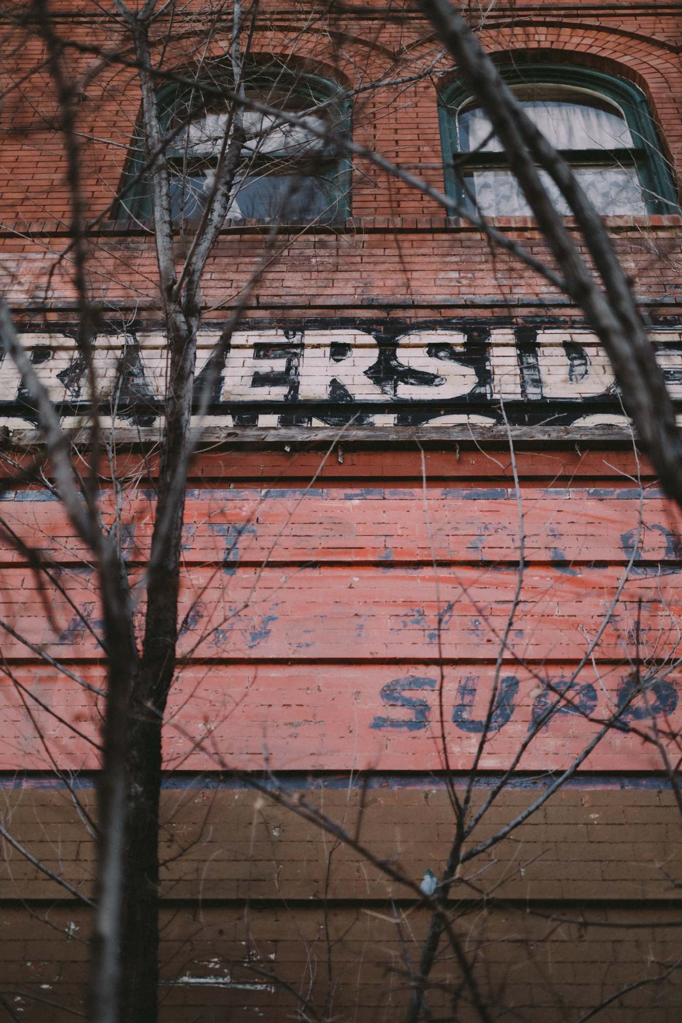 Weathered Signage and Advertising Painted on Brick