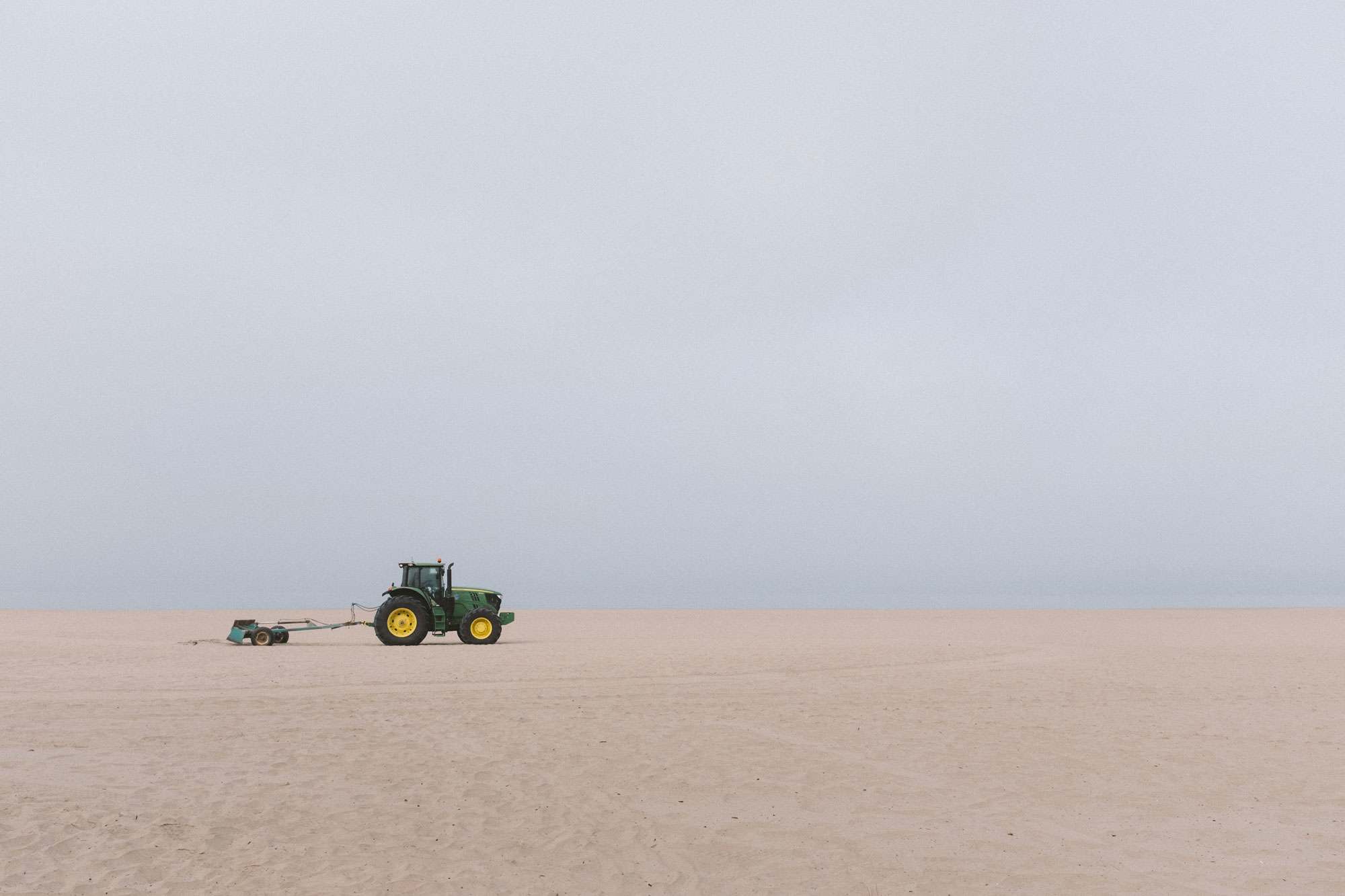 Tractor Smoothing the Sand on the Beach