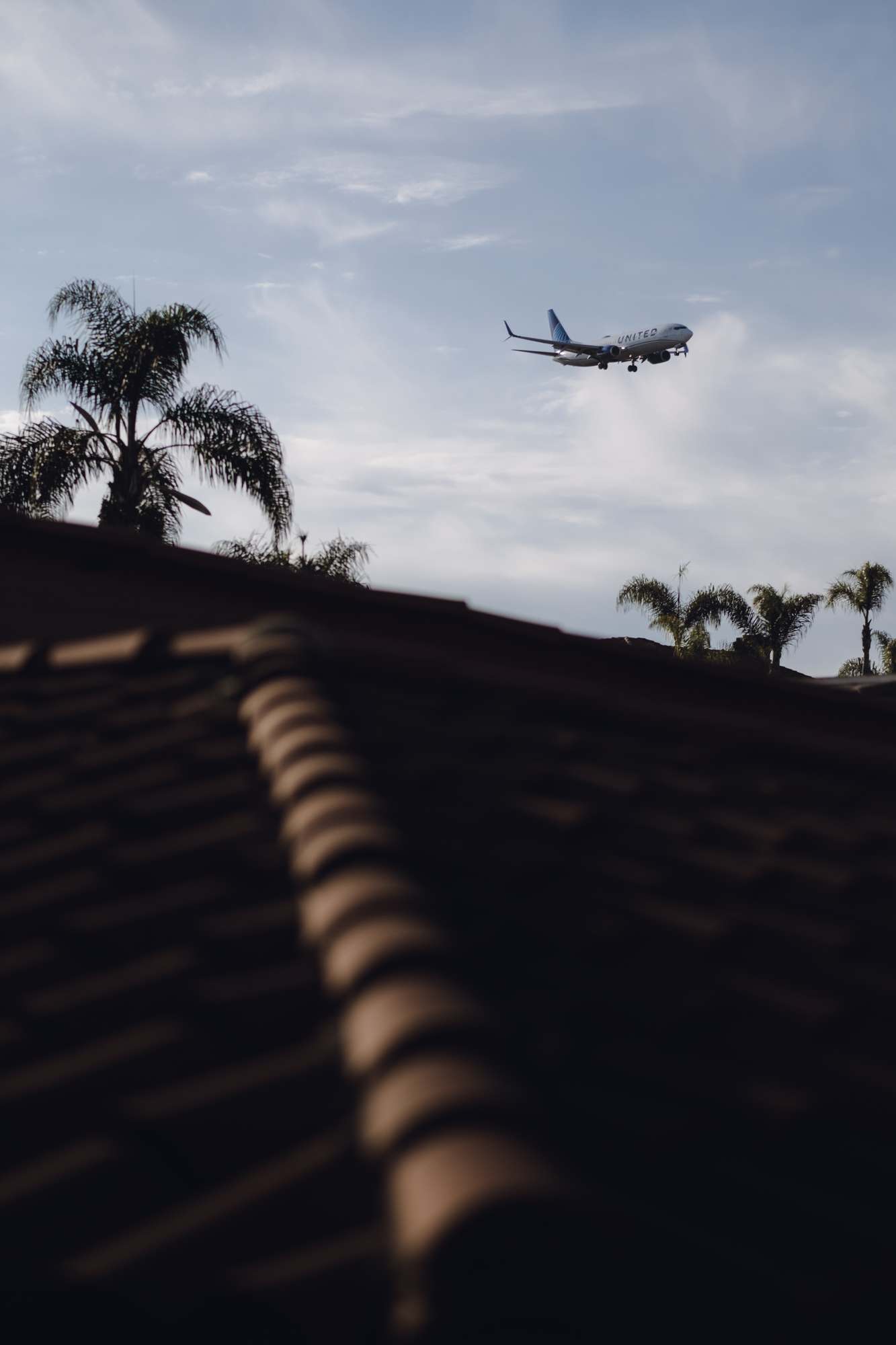 A United Airlines Plane Comes Into View Landing at SAN